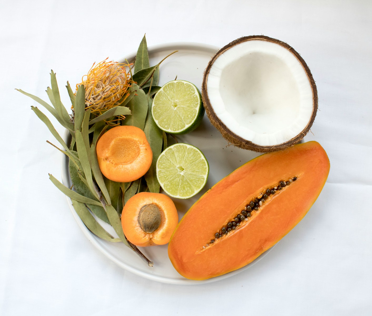 sliced fruits served on white plate