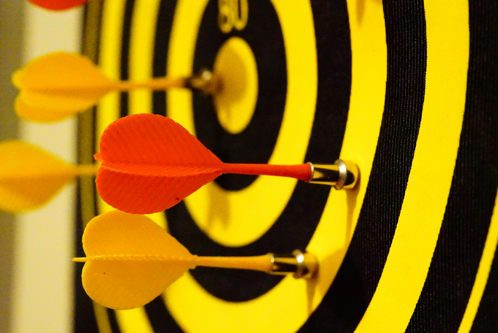 black and yellow dartboard with magnet darts