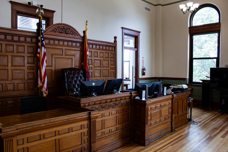 Interior view of an American courthouse in Kirksville, Missouri, featuring a judge's desk and flags.