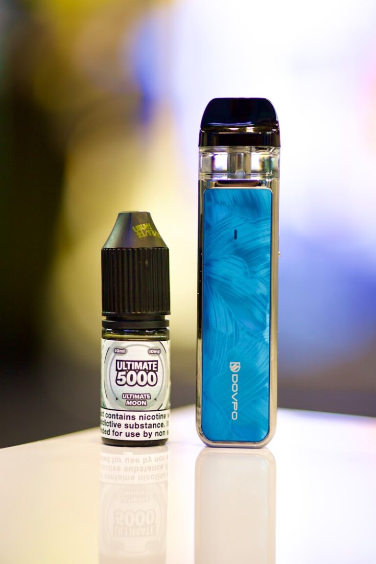 an electronic device next to a bottle of liquid