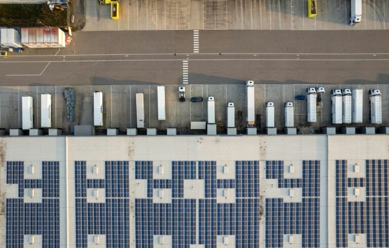 An aerial view of a parking lot with cars